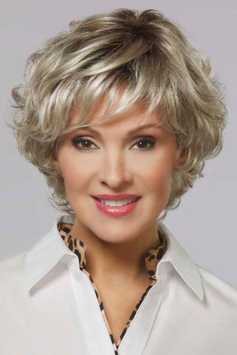 Woman in a short, curly ash blonde bob lace front wig with side bangs