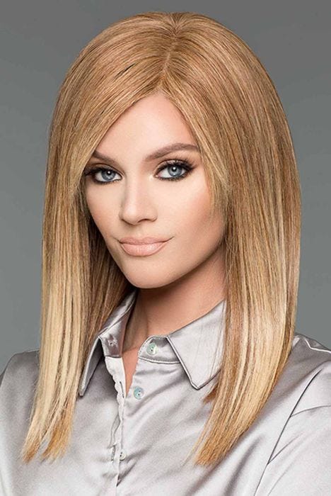 Woman in a past the shoulders straight light auburn human hair wig