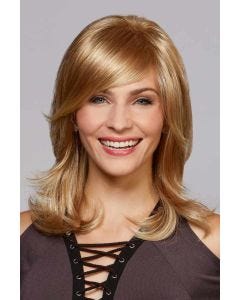 Woman in a shoulder length dark blonde long layered bob wig with side bangs