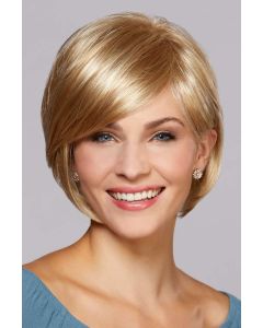 Woman in a chin length light gold blonde bob wig with long side bangs