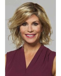 Woman in a shoulder length gold blonde curly bob wig with layers