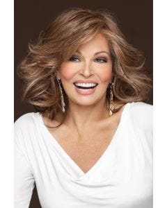 Raquel Welch in a just past the shoulders medium auburn long layered wig with long side swept bangs