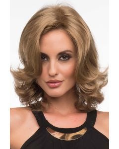 Woman in a layered shoulder length curly ash blonde wig