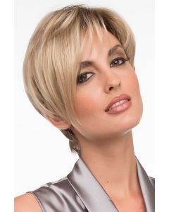 Woman in an asymmetric short blonde pixie wig with textured bangs