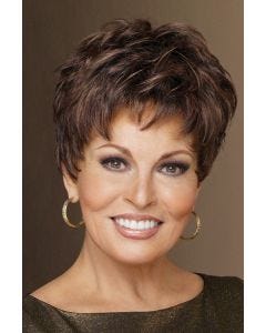Woman in a short, semi-wavy pixie wig with short textured bangs