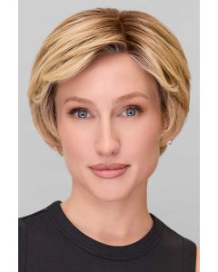 Woman in a blonde classic pixie style wig with feathered bangs and darker layers