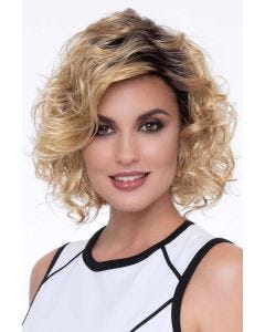 Woman in a shoulder length light blonde curly wig with long layers