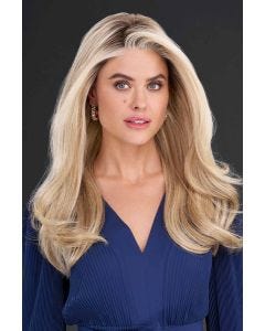 Woman in long, wavy strawberry blonde wig with with long side-swept bangs framing the face