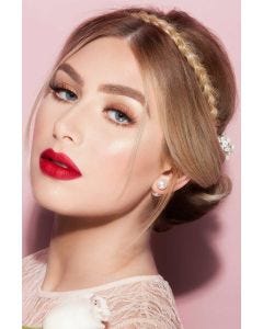 Woman in a light brown braided hair headband in her hair