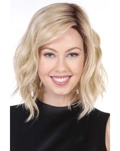Woman in a shoulder length light blonde wavy lace front wig