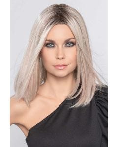 Woman in a past the shoulders platinum blonde straight blunt lace front wig