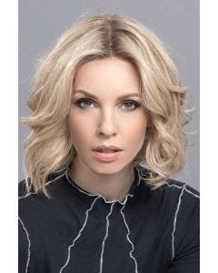 Woman in a chin length curly light blonde human hair/synthetic blend wig