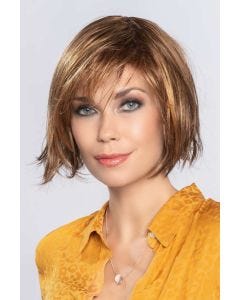 Woman in a chin length auburn rounded bob wig with side bangs