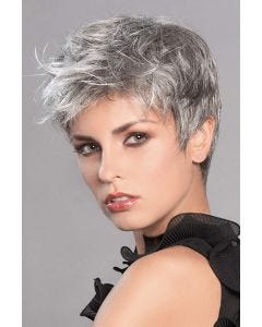 Woman in a grey pixie wig with longer tousled hair on top