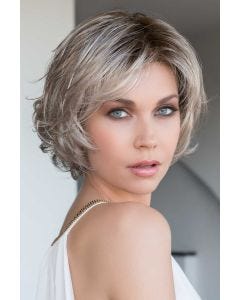 Woman in a chin length ash blonde bob wig with side bangs