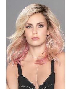 Woman in a past the shoulders blonde and pink curly lace front wig with dark roots