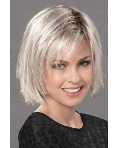 Woman in a chin length razor cut platinum blonde lace front wig