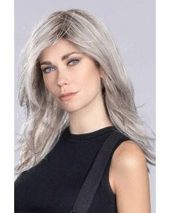 Woman in an extra long light grey long-layered lace front wig