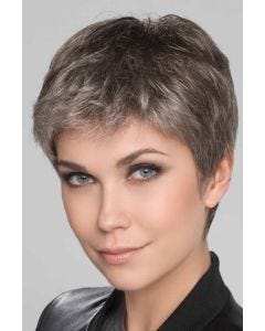 Woman in a light brown lace front pixie wig