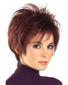 Woman in a spiky burgundy long pixie wig with wispy bangs