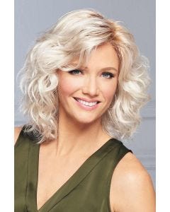 Woman in a shoulder length platinum blonde curly lace front wig with side bangs