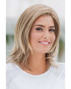 Woman in a shoulder length blonde wig with choppy layers