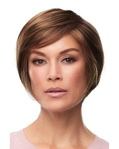 Woman in a layered chin length medium auburn rounded bob wig with bangs