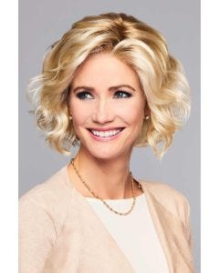 Woman in a large chin length light blonde curly lace front wig