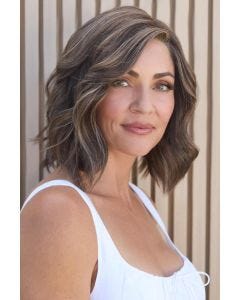 Woman in an auburn shoulder length blunt bob wig with curled under ends