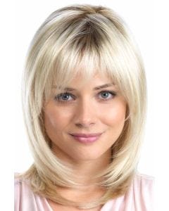 Woman in a past the shoulders platinum blonde layered wig with arched bangs