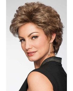 Woman in a semi-long medium brown curly pixie wig