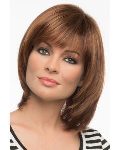 Woman in a shoulder length light auburn blunt bob wig with shorter layers along the face and fringe bangs