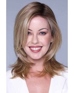 Woman in a shoulder length medium blonde wig with long layers