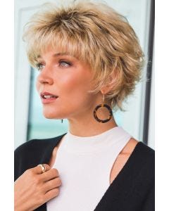 Woman in short blonde wig with textured layers and bangs