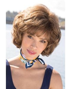 Woman in short to chin length bob wig with layers, waves and bangs