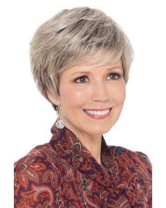 Woman in short blonde rooted pixie wig with bangs
