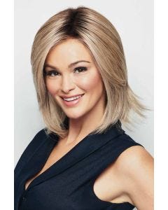 Woman in a shoulder length light blonde wig with long layers and long side bangs