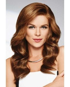 Woman in a long wavy medium auburn wig with a side part and long side layers