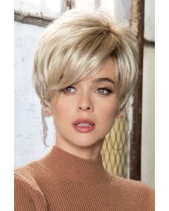 Woman in blonde short wig with longer layers and slight waves in back