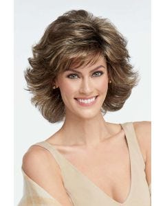 Woman in a medium brown, shoulder length blown out wig with dramatic layers and fringe bangs