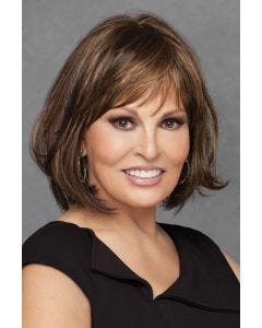 Woman in shoulder length brunette wig with light brown highlights and bangs