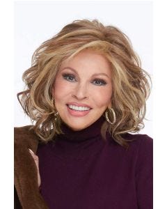 Raquel Welch in a shoulder length ginger blonde curly wig with wispy bangs