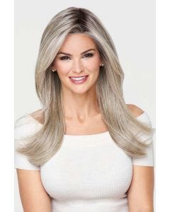 Woman in an extra long warm blonde lace front wig with dark roots