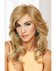 Woman in a large extra long curly warm blonde wig with side bangs