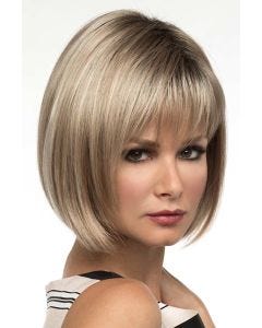 Woman in a chin length ash blonde bob wig with fringe bangs