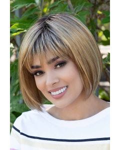 Woman in a chin length light blonde blunt bob wig with textured bangs