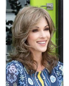 Woman in a past the shoulders curly dark auburn human hair wig