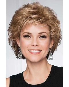 Woman in a short light brown bob wig with curled layers and fringe bangs