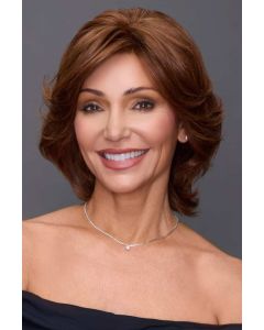 Woman in a medium auburn short and wavy shag wig with side swept bangs