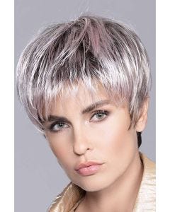 Woman in a brushed forward long grey and light pink pixie wig with dark roots